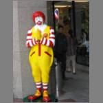 Ronald McDonald with his hands folded in traditional Thai greeting - the "wai"